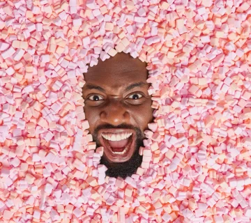 Man surrounded by pink and orange marshmallows 2026 03 17 02 40 22 utc 360x320