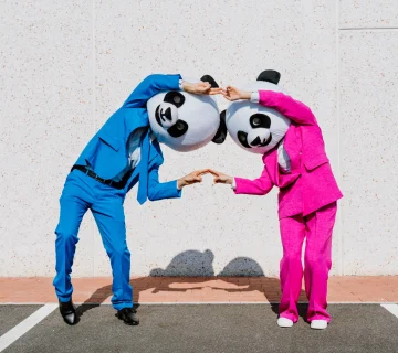 Panda mascot duo in colorful suits playfully posin 2026 03 24 11 20 19 utc 1 360x320