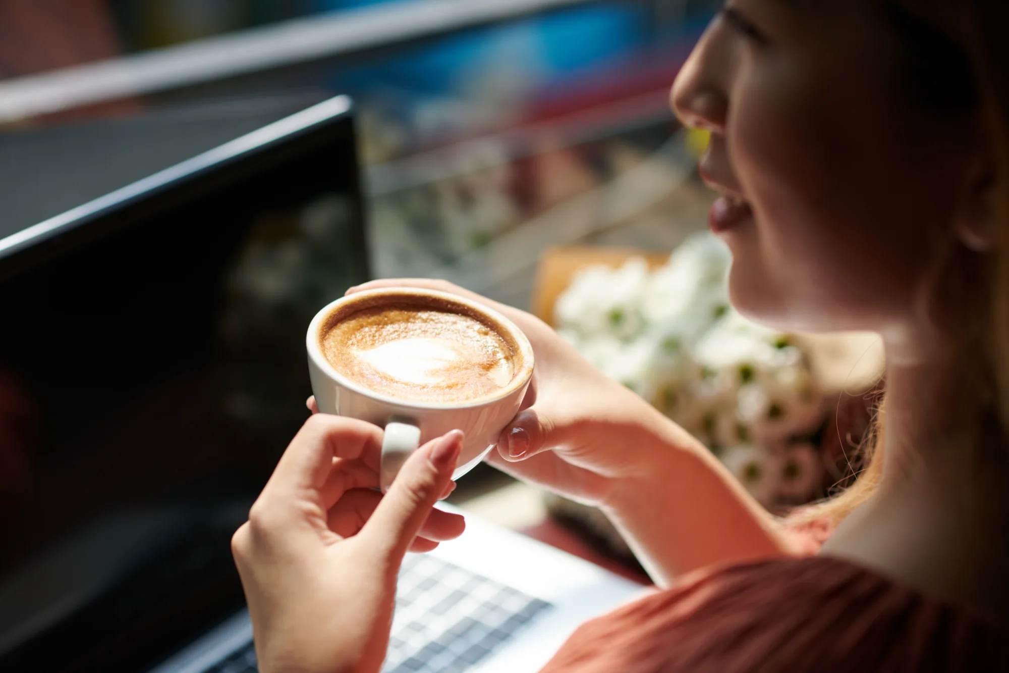 Woman enjoying coffee while working on laptop 2026 03 18 14 55 10 utc